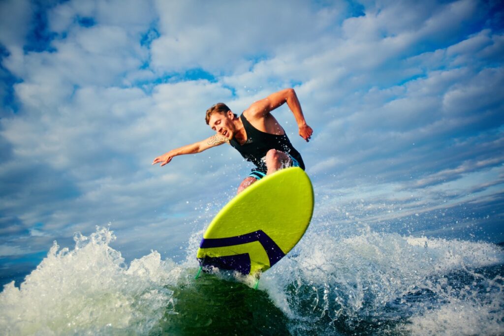 Children and adults taking surf lessons in Tamarindo, improving their surfing skills in a warm, sunny beach environment.